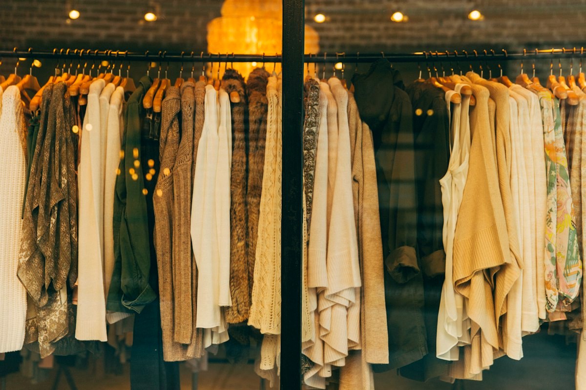 A rail of soft-toned clothing in a boutique
