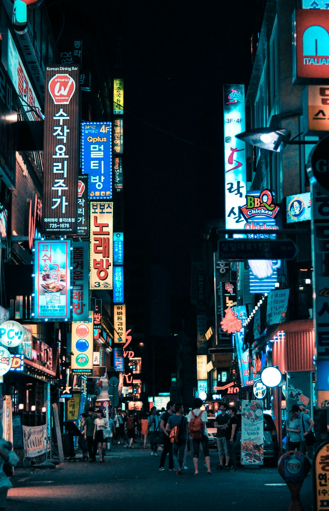 Neon-lit shopping street in Seoul at night